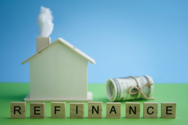 Mortgage,And,Home,Refinance,Conceptual,With,Wooden,House,On,Green